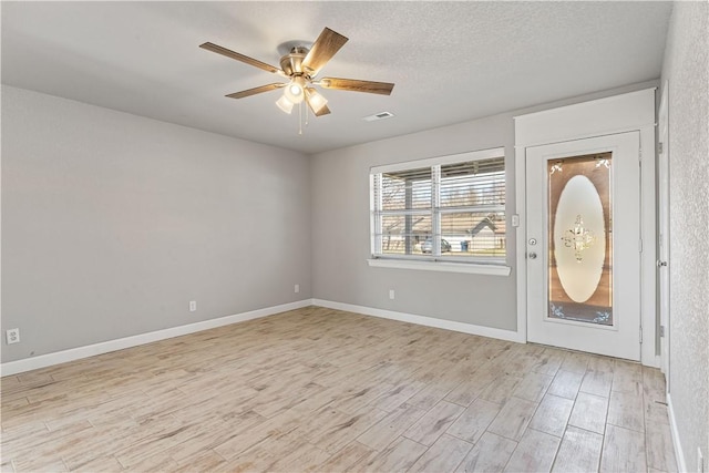 interior space featuring a textured ceiling, ceiling fan, and light hardwood / wood-style flooring