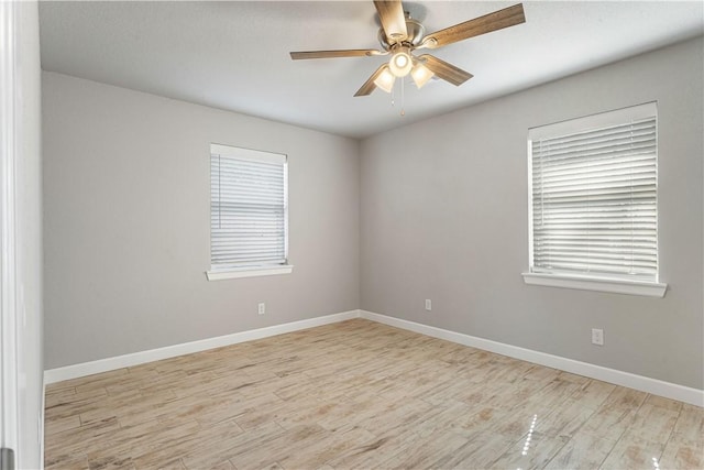 spare room featuring light wood-type flooring and ceiling fan