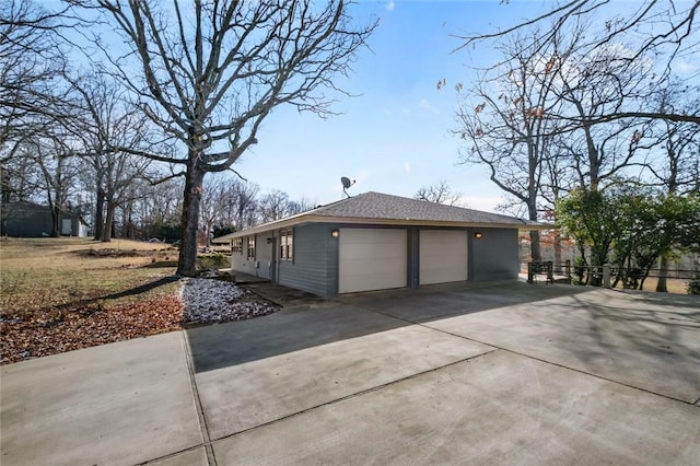 view of home's exterior with a garage and concrete driveway