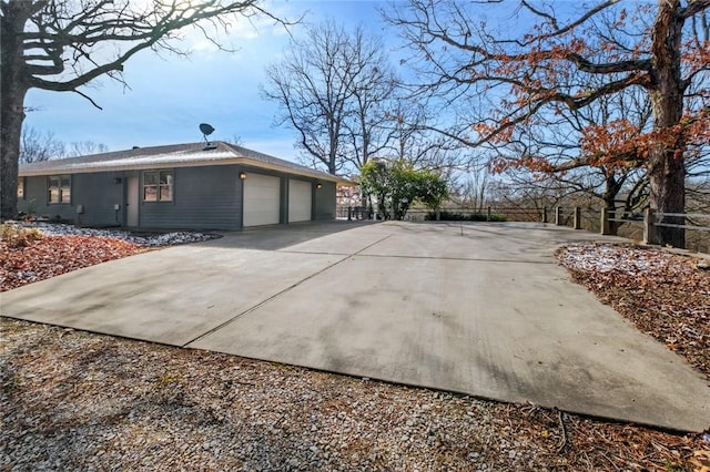 view of home's exterior featuring an attached garage and driveway