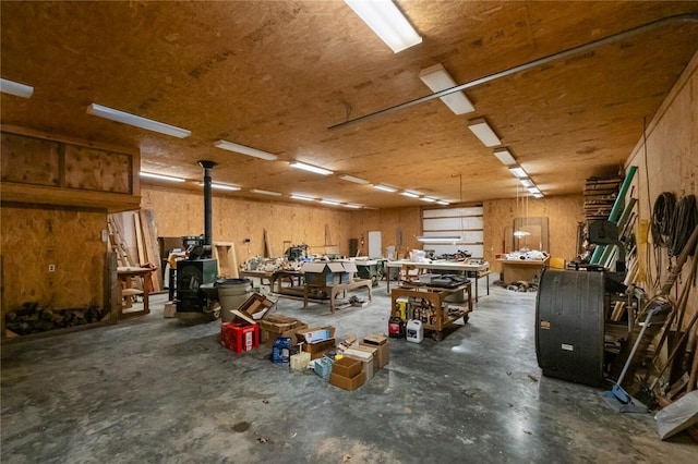 garage featuring a workshop area and a wood stove