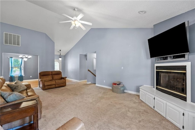 living room with ceiling fan with notable chandelier, high vaulted ceiling, and light carpet