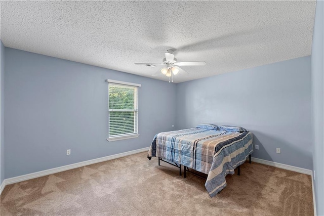 bedroom with a textured ceiling, light carpet, and ceiling fan