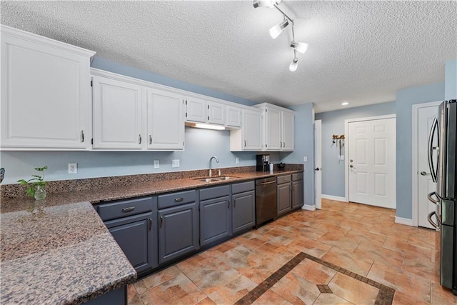 kitchen featuring sink, a textured ceiling, white cabinets, and stainless steel appliances