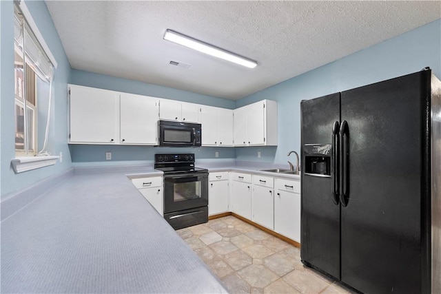 kitchen featuring white cabinetry, sink, black appliances, and a textured ceiling