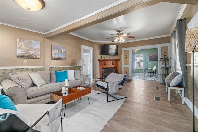 living room with ceiling fan, crown molding, and hardwood / wood-style floors