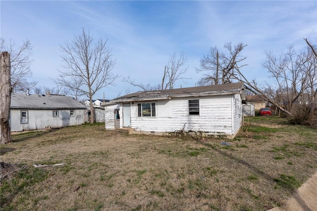 rear view of house with a lawn