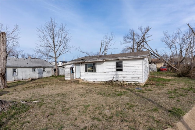 back of property with a lawn and crawl space