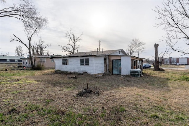 back of property with a lawn