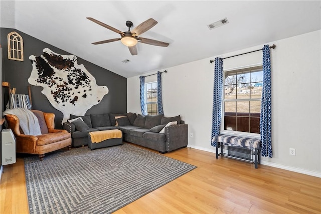 living room with vaulted ceiling, ceiling fan, and hardwood / wood-style flooring