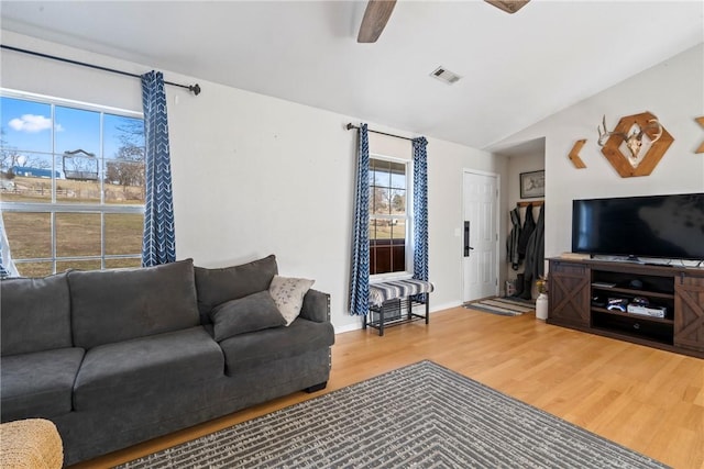 living room featuring vaulted ceiling, ceiling fan, and wood-type flooring