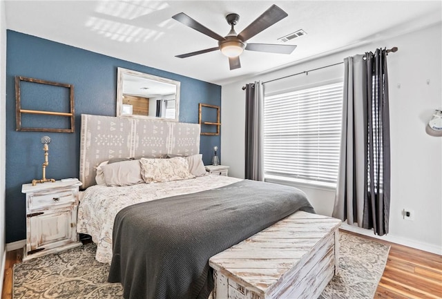 bedroom with light hardwood / wood-style flooring and ceiling fan