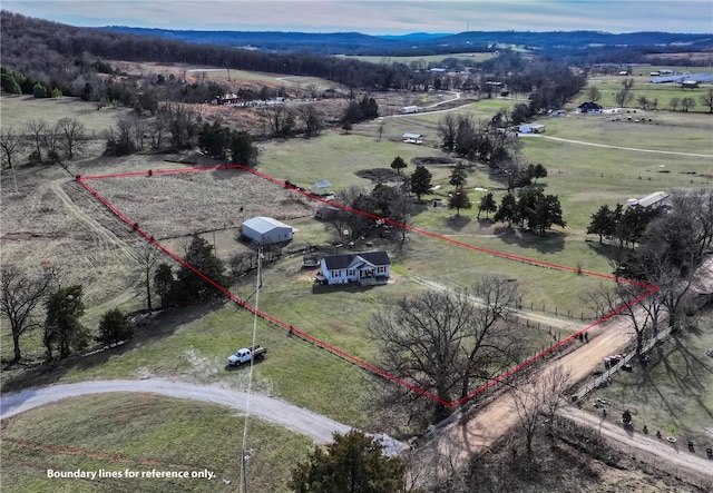 drone / aerial view featuring a mountain view and a rural view