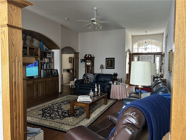 living room featuring ceiling fan and dark wood-type flooring