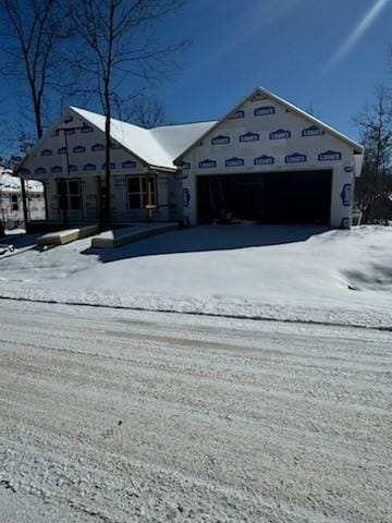 unfinished property featuring driveway and a garage