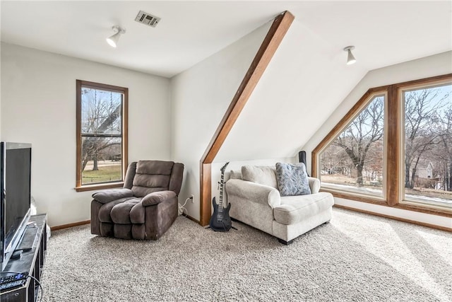 sitting room with carpet floors, lofted ceiling, visible vents, and plenty of natural light