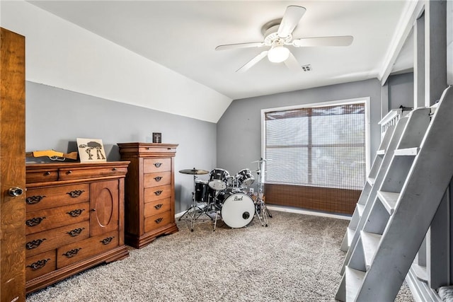 recreation room with visible vents, a ceiling fan, vaulted ceiling, and carpet flooring