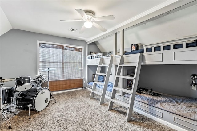 bedroom with carpet flooring, vaulted ceiling, visible vents, and ceiling fan