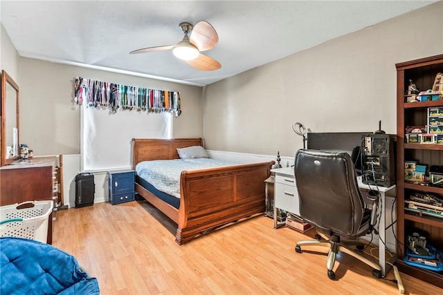 bedroom with light wood finished floors and ceiling fan