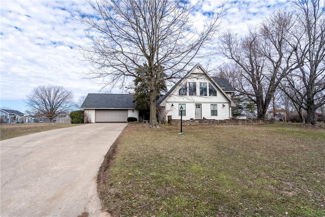 view of front facade with a garage, a front yard, and driveway