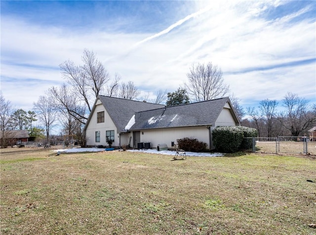 view of home's exterior featuring central AC unit, fence, and a yard