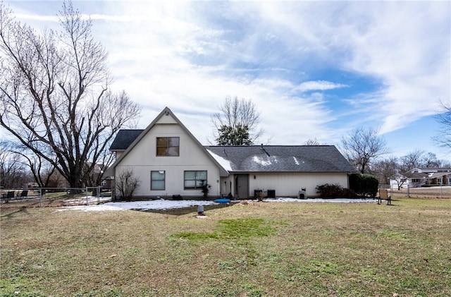 back of house with a yard and fence