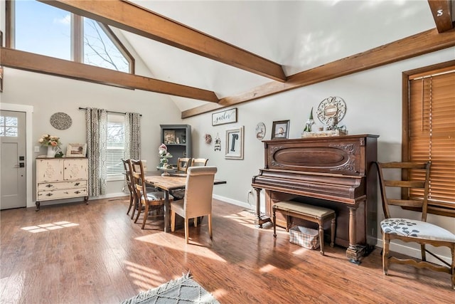 dining space featuring high vaulted ceiling, baseboards, beam ceiling, and wood finished floors