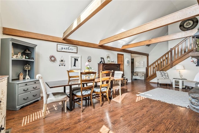 dining room featuring lofted ceiling with beams, baseboards, stairway, and dark wood finished floors