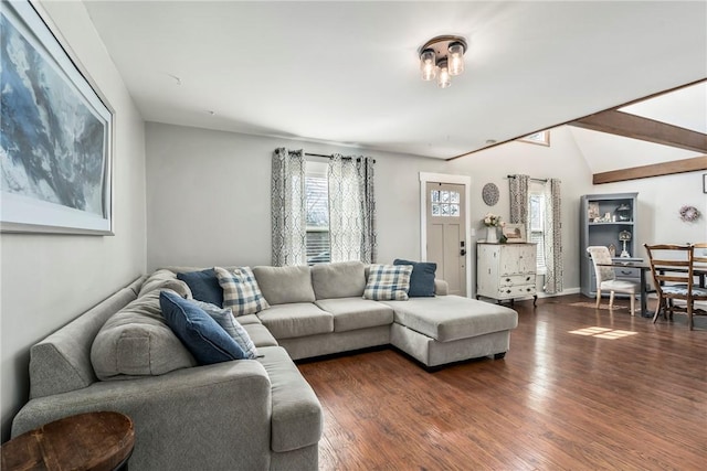 living area with dark wood-style floors and lofted ceiling