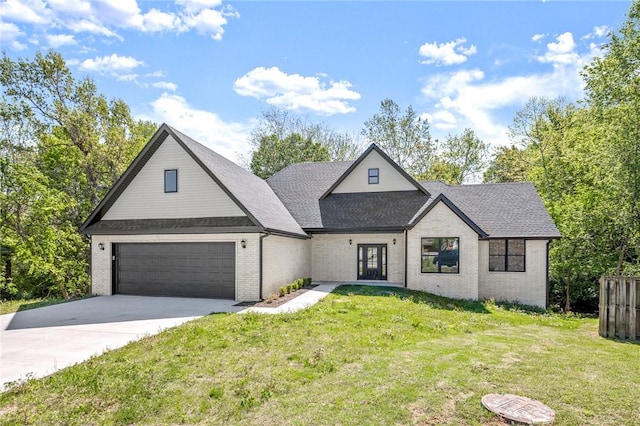 view of front of home with a front yard and a garage