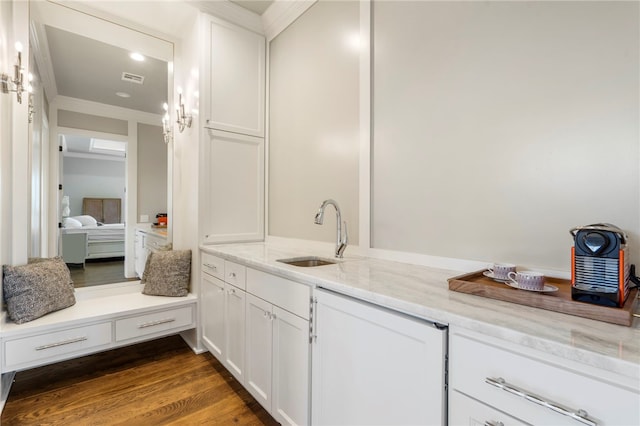 bathroom featuring ornamental molding, vanity, and wood-type flooring