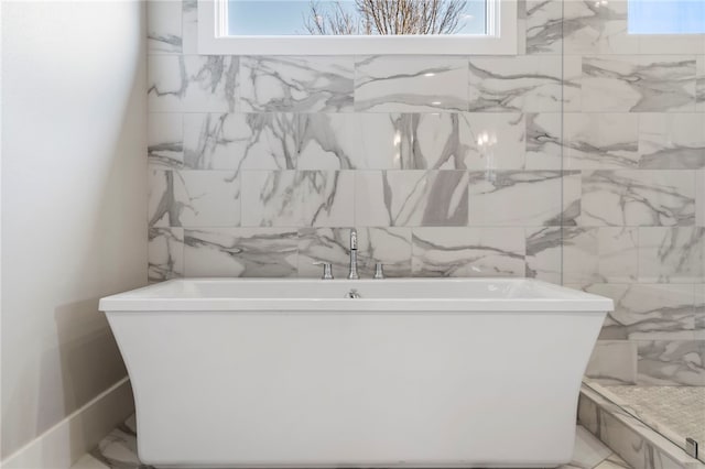 bathroom with a tub to relax in