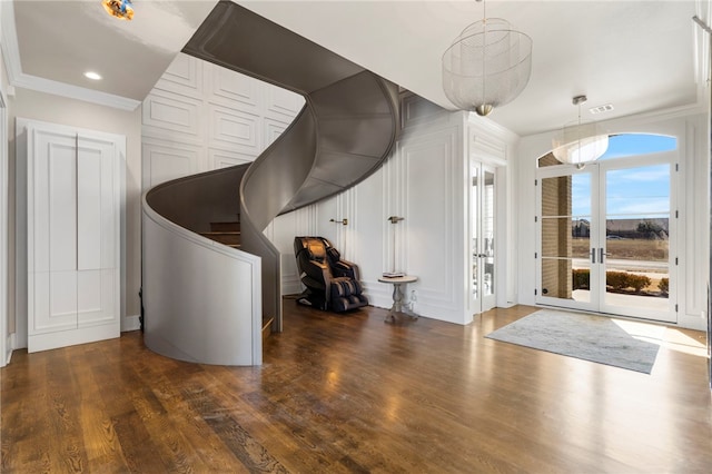 interior space with french doors, crown molding, and dark hardwood / wood-style flooring