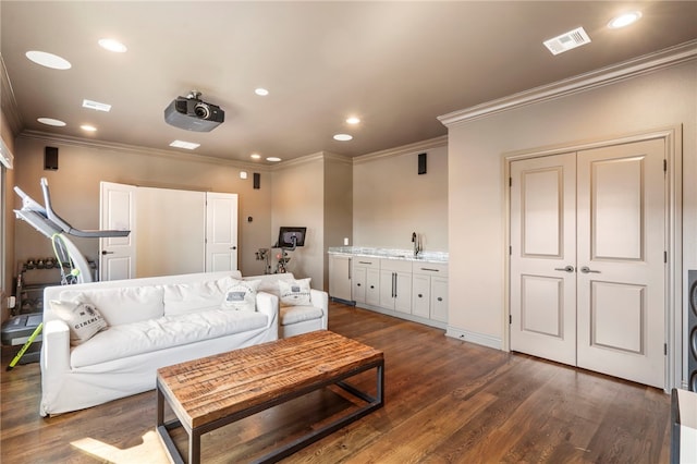 living room with ornamental molding, dark wood-type flooring, and sink