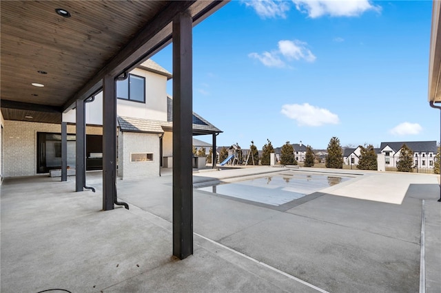 view of pool with a playground and a patio area