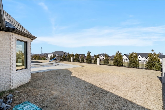 view of yard with a fenced in pool and a patio area