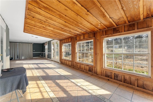 unfurnished sunroom featuring wooden ceiling