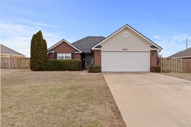 ranch-style house featuring driveway, fence, and brick siding