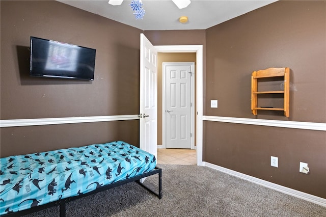 bedroom featuring light carpet and baseboards