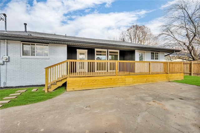 view of front of house with brick siding and fence