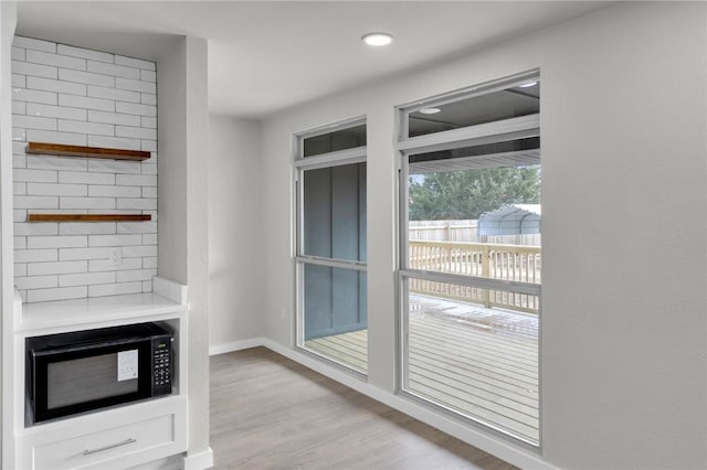 interior space featuring light wood-style floors and baseboards