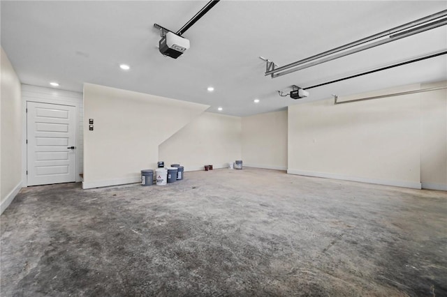 garage featuring baseboards, recessed lighting, and a garage door opener