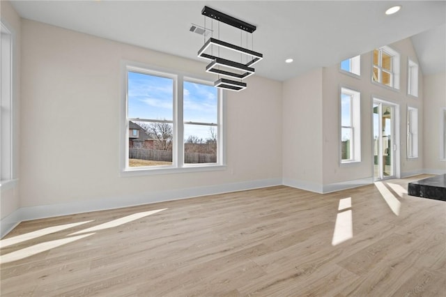 unfurnished living room featuring light wood-style floors, baseboards, and recessed lighting