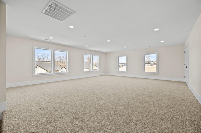 unfurnished living room with light carpet, baseboards, visible vents, and recessed lighting