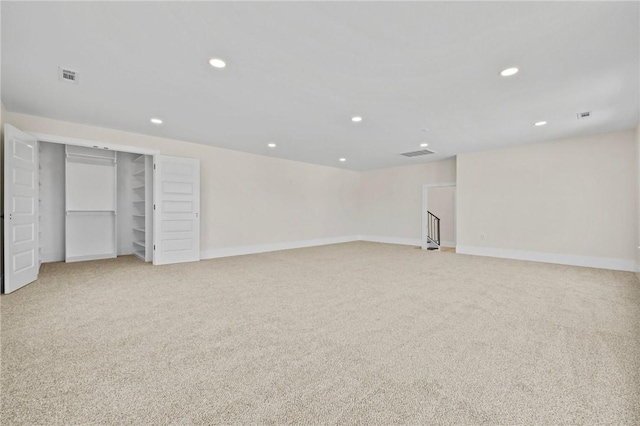 interior space with recessed lighting, visible vents, baseboards, and light colored carpet