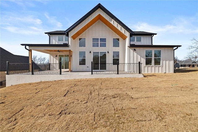 back of property featuring a patio, fence, a ceiling fan, a yard, and board and batten siding