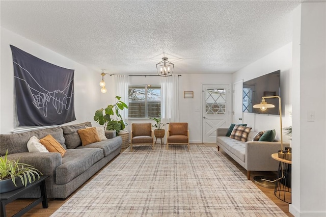 living room featuring a textured ceiling and wood finished floors