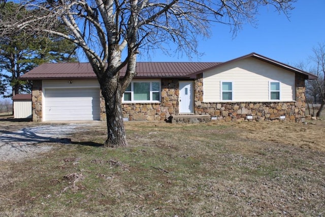 ranch-style house featuring metal roof, a garage, dirt driveway, stone siding, and crawl space