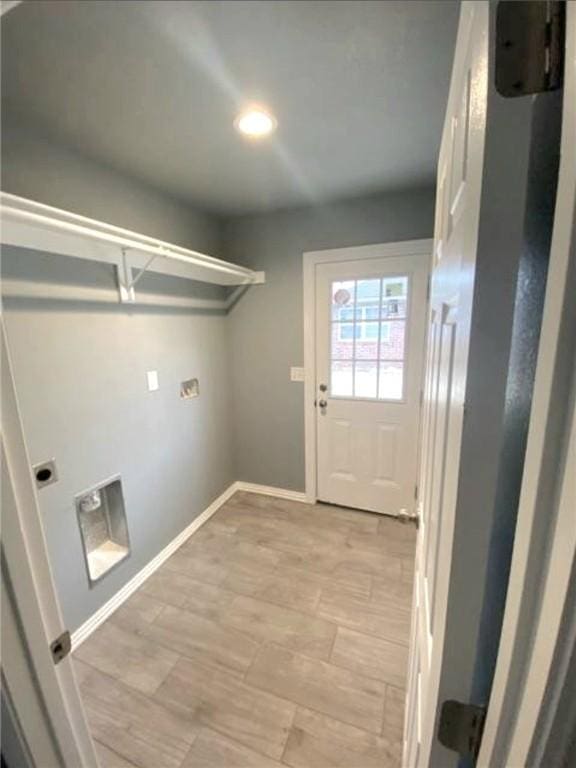 laundry area with laundry area, baseboards, and hookup for an electric dryer