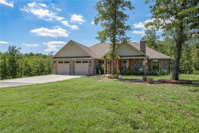 craftsman house featuring a garage, driveway, a chimney, and a front lawn